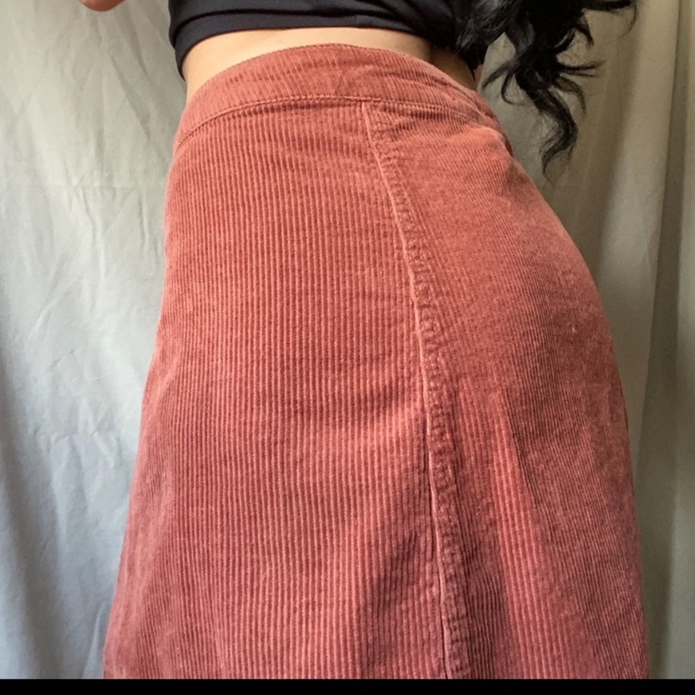 A warm orange, fall, ribbed skirt.
with buttons all the way down.